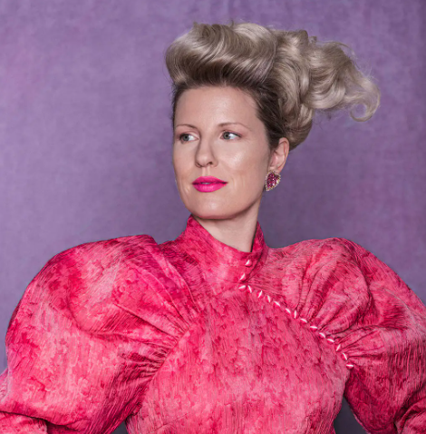 Sculpted blonde updo and pink styling