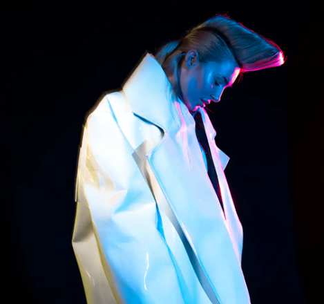 Sculptural hair and an iridescent jacket
