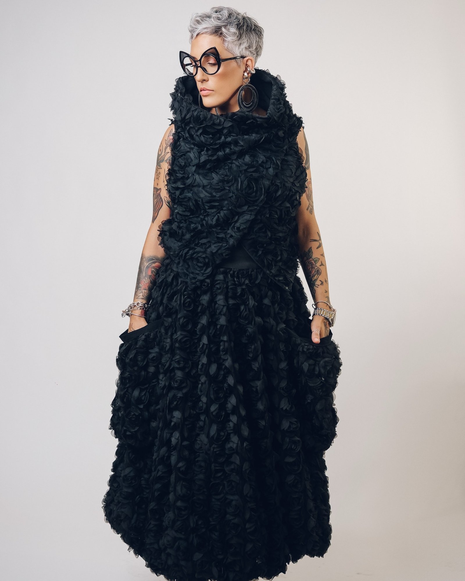 Jelena with short silver curls, black glasses and a textured black dress — Edu X-perience
